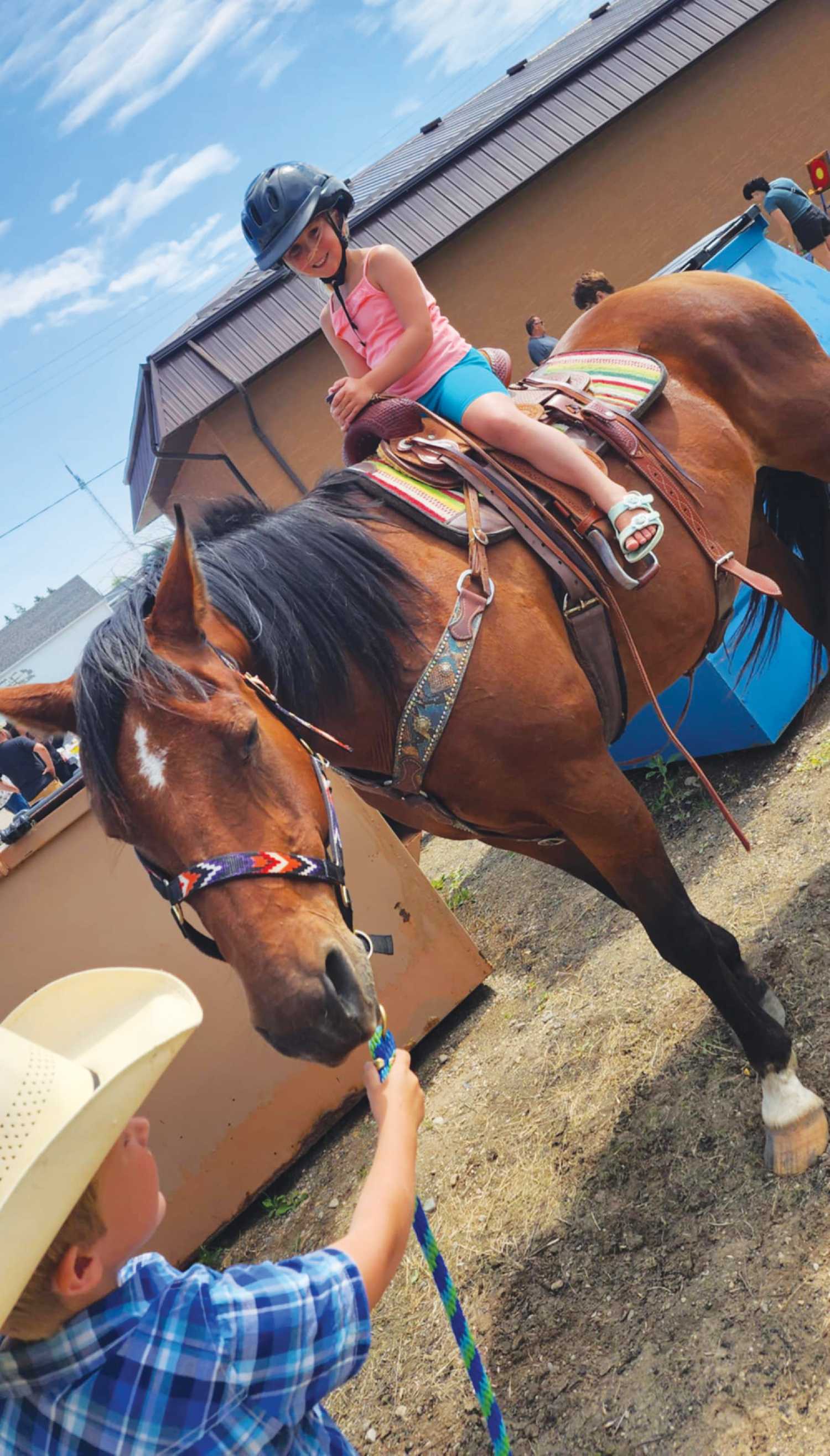 Paige Herperger sits high in the saddle during last weeks barbecue and petting zoo fundraiser at Twin Valley Veterinary Health Services. Proceeds from the fundraiser went to the Little Miners Community Daycare.